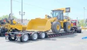 image of Lowboy trailer hauling a Caterpillar Bull Dozer