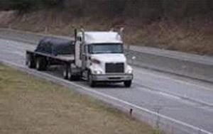 Flat bed trucking is moving on a highway