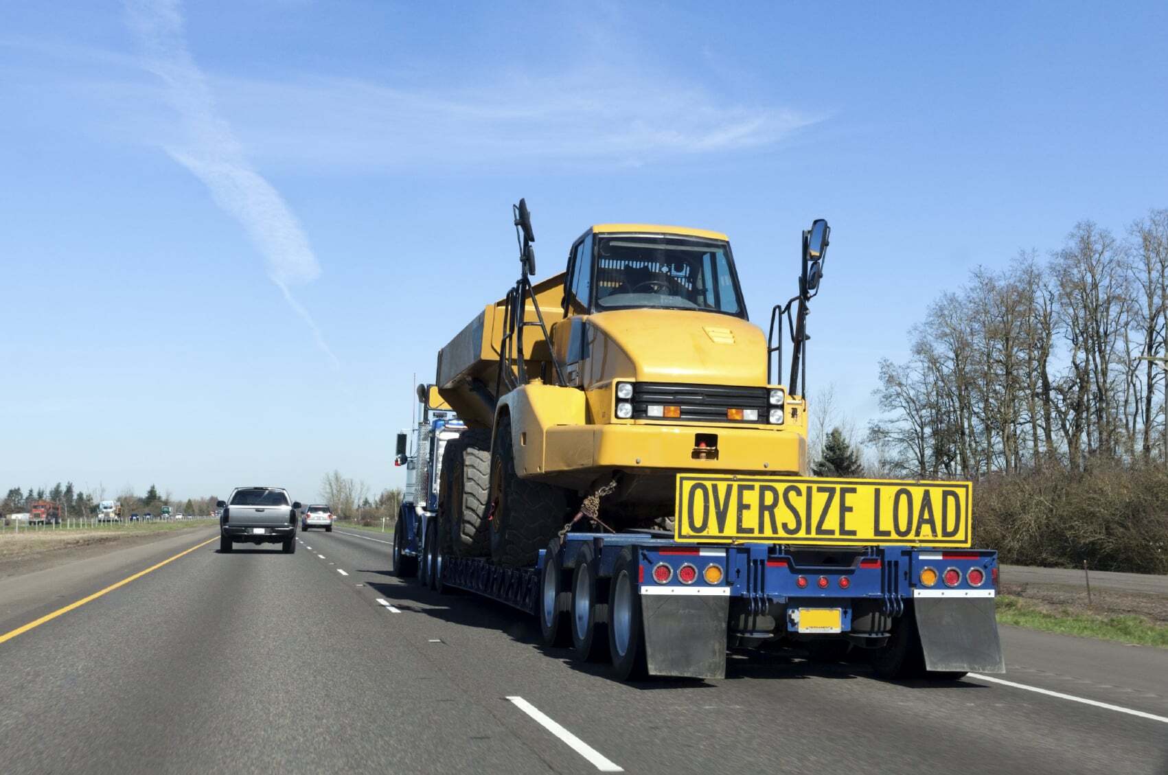 Oversize load being hauled on a lowboy trailer